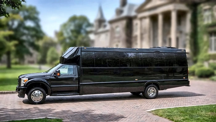 The black Ford F-550 Party Bus in side view