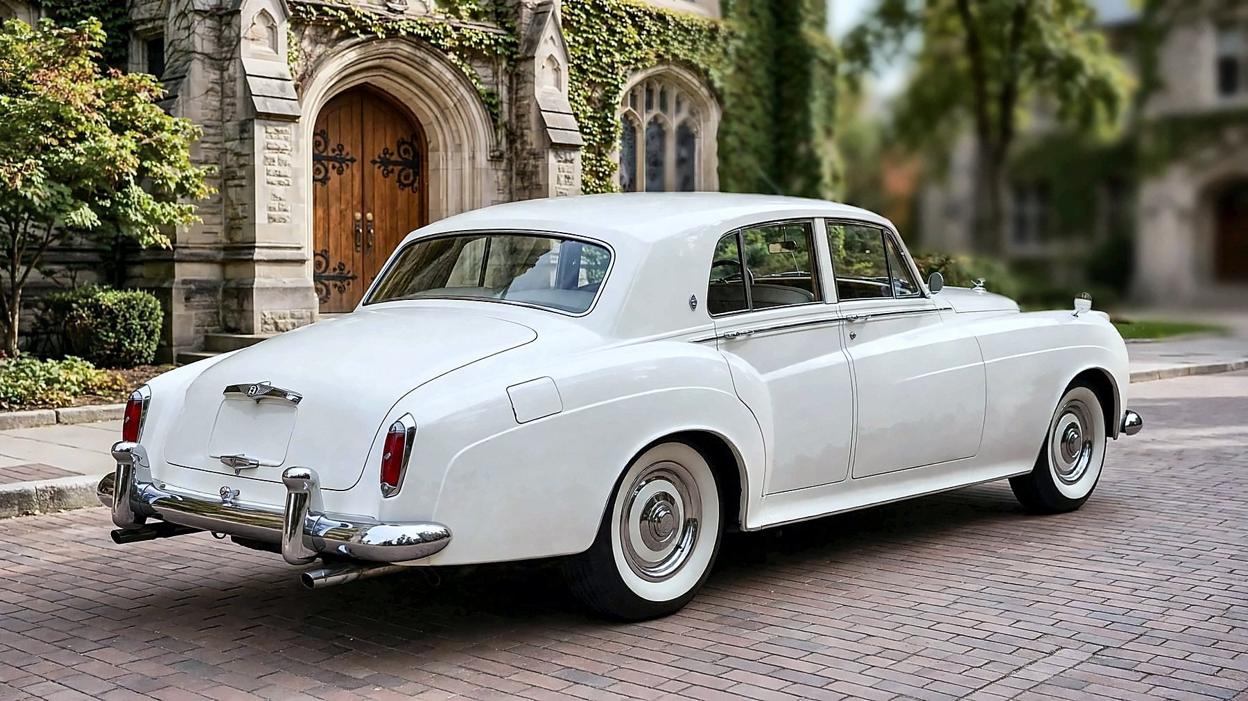 The white 1959 Bentley S from the rear, on a university campus