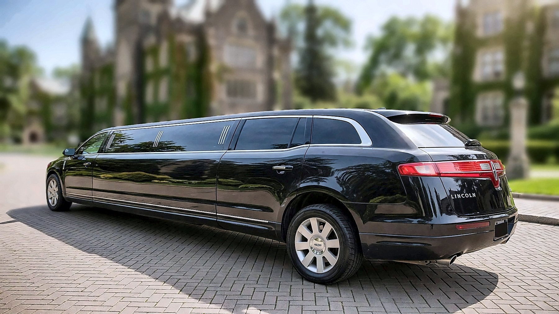 The black Lincoln MKT Stretch from the rear on a university campus