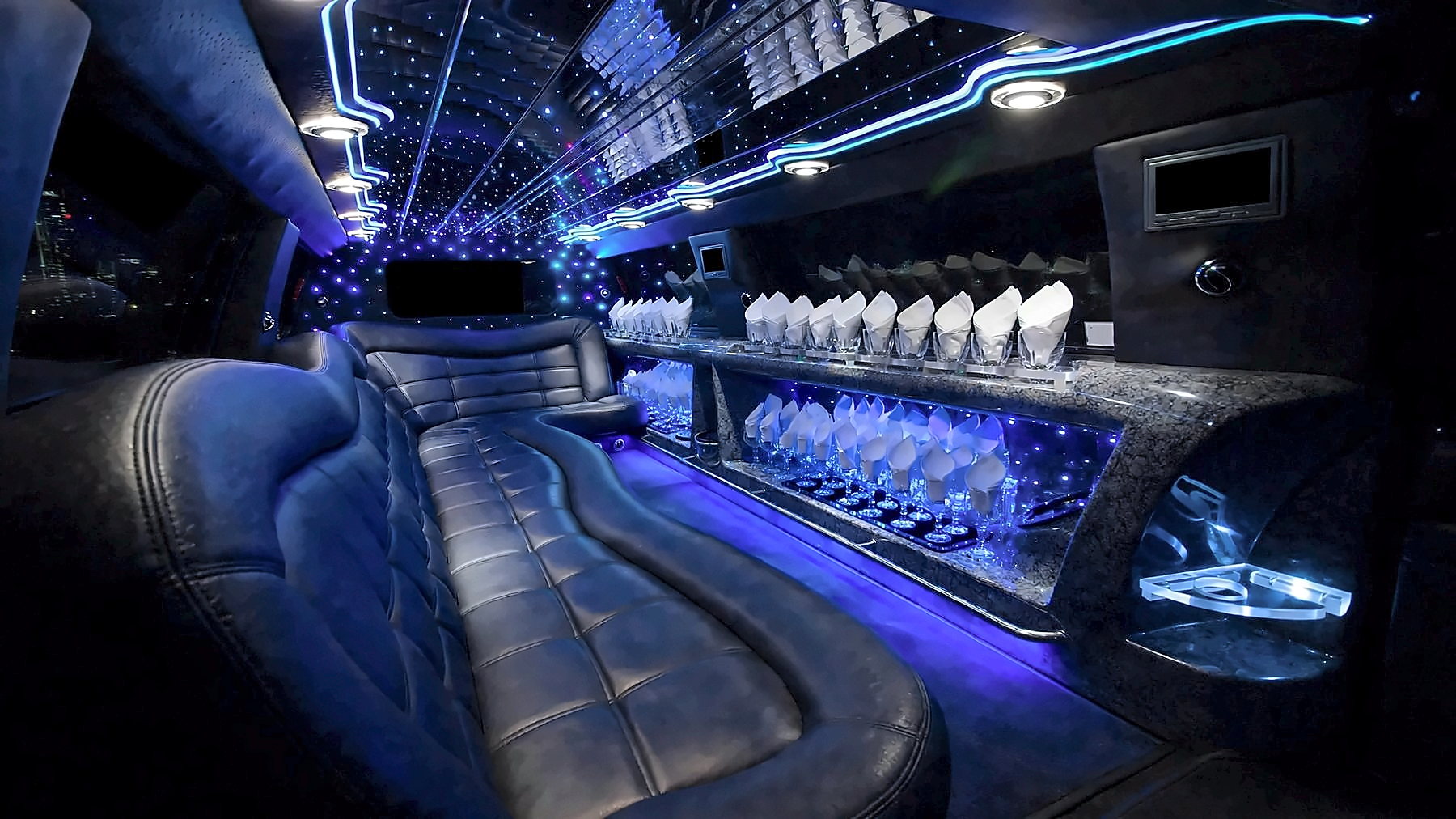 Interior of the 12-passenger Lincoln Navigator Stretch Limousine with a starlight ceiling and blue cabin lighting