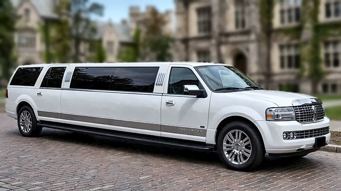 The white 12-passenger Lincoln Navigator Stretch Limousine, available for airport transfers
