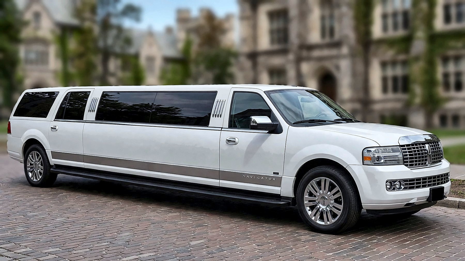 The white 12-passenger Lincoln Navigator Stretch Limousine from the front right, showing the full length of the stretch