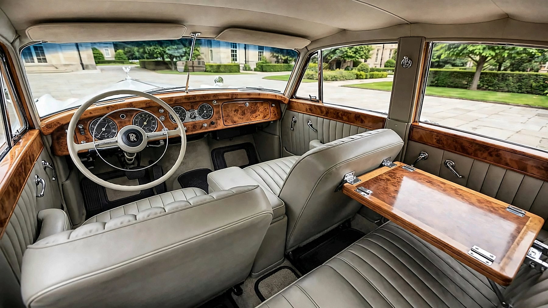 The light grey-beige leather and walnut interior of the 1959 Rolls-Royce, with left-hand steering