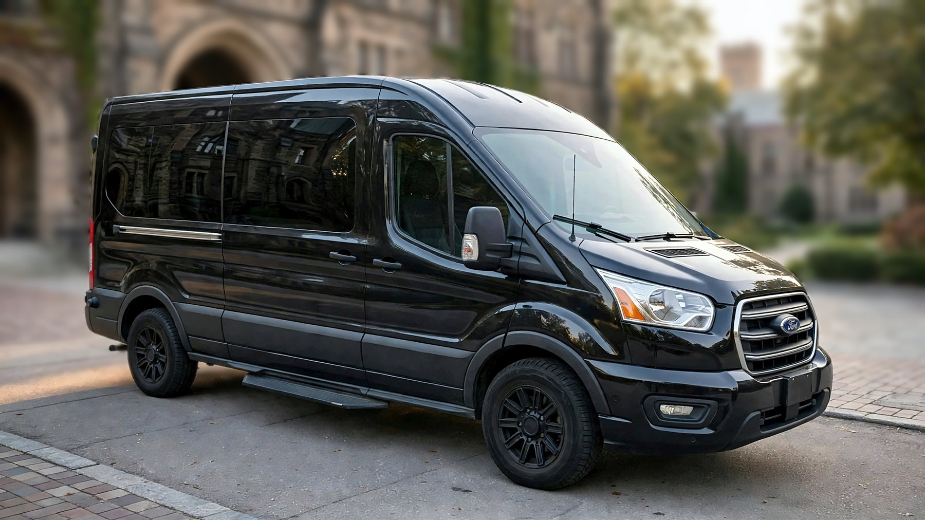 The black Ford Transit 250 from the front right on a university campus